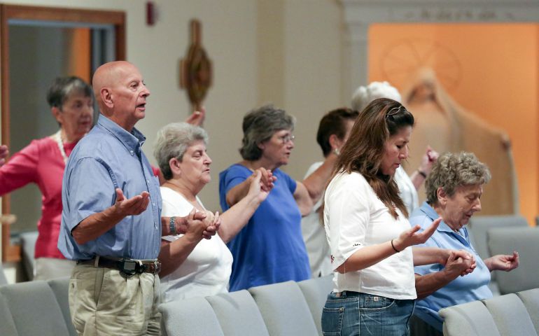 Should we hold hands or not during the Our Father? | National Catholic